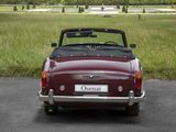 a red convertible car parked on the side of the road