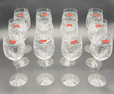 six clear wine glasses are lined up in a row on a table