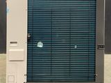 a blue and white air conditioner sitting outside of a building
