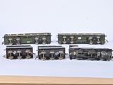 four toy trains sitting on a table next to each other