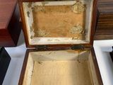 a small wooden box sitting on a table next to other wooden boxes