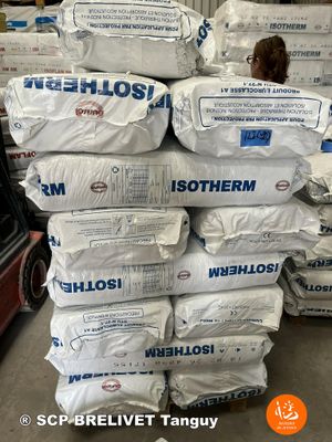 a large stack of bags of cement in a warehouse