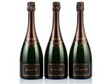 three bottles of champagne in a row on a white background