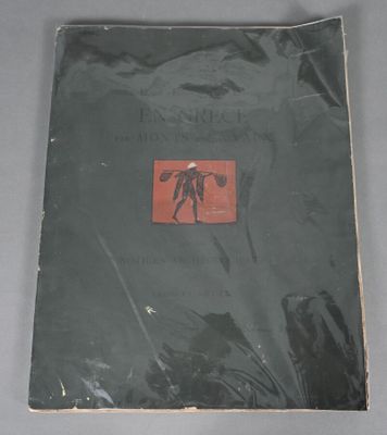 an old book sitting on top of a table next to a black bag