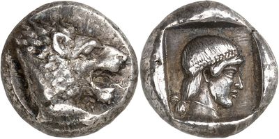 a close up of a silver coin with a head of a woman