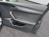 the door of a car with a dog sitting in it ' s seat