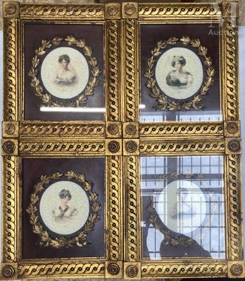 four framed portraits of women in ornate gold frames on a wall