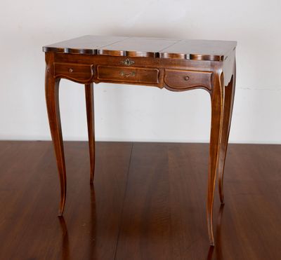 a small wooden table with a marble top on a wooden floor