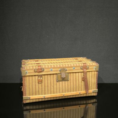 un petit coffre en bois posé sur une surface noire