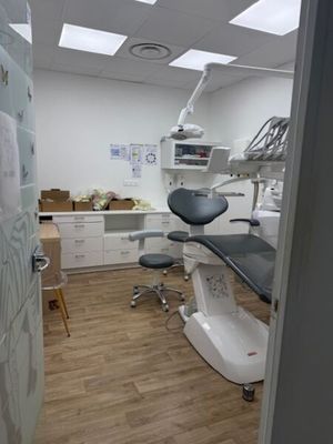 an image of a dentist ' s office with a desk and chairs