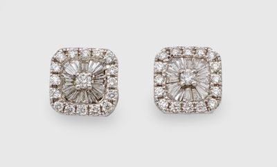 a pair of diamond earrings on a white background