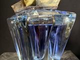 a bottle of perfume sitting on top of a table