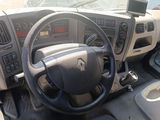 a steering wheel and dashboard of a vehicle in a parking lot
