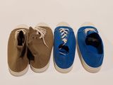three pairs of shoes are lined up in a row on a white surface