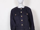 a mannequin mannequin wearing a black dress with gold buttons