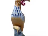 a figurine of a bird sitting on top of a rock