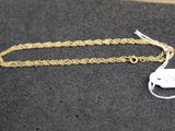 a close up of a gold chain with a tag on it