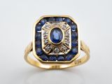 gros plan d'une bague en or avec saphirs bleus et diamants