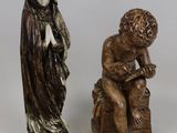 three figurines of a man and a woman sitting on a bench