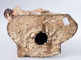 a piece of pottery that has a hole in it