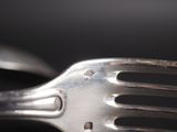 a close up of a fork and a knife on a table