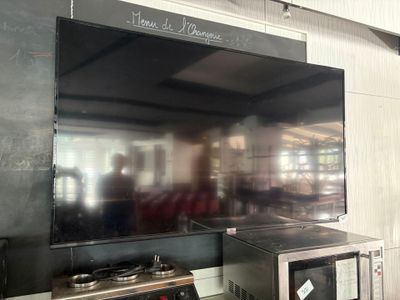 a television mounted on the wall in a kitchen