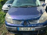 the blue car is parked in the grass next to other cars