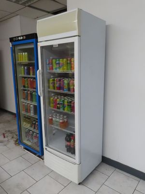 two refrigerators that are next to each other in a room