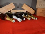 several bottles of wine are lined up on a red table cloth