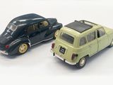 two toy cars sitting next to each other on a white surface