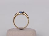 a close up of a gold ring with a blue sapphire stone