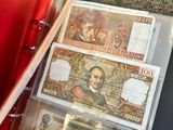 a red folder with money inside of it on the floor