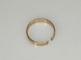 an image of a gold ring sitting on top of a white surface