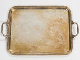 an antique brass tray with handles and handles on a white surface