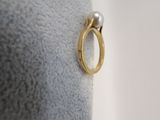 a gold ring with a pearl on top of it