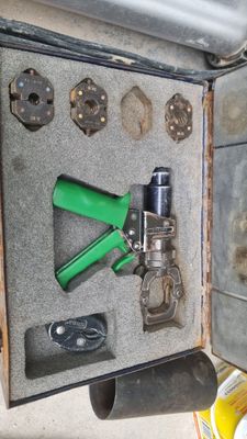 an open suitcase with tools in it sitting on the floor