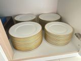 many plates stacked on top of each other in a cabinet