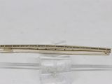 pair of gold tone hair clips on a clear acrylic stand