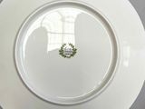 a white plate with a wreath on it on a table