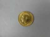 a gold coin with a picture of a man on it