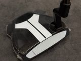 a close up of a putter on the ground
