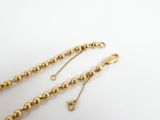 a close up of a gold chain with a clasp on it