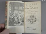 un livre ouvert sur lequel figure le dessin d'une famille dans un salon