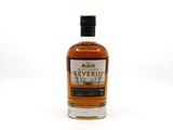 a bottle of whisky sitting on top of a white surface