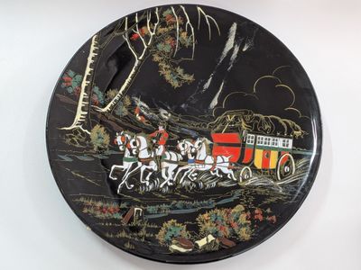 a black plate with a picture of a train on it