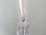 a glass vase with a candle inside of it on a table