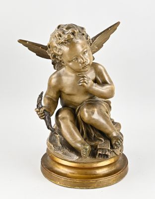 an antique bronze statue of a cupid holding a bird on a wooden base