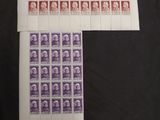 a black table topped with lots of stamps on top of a table