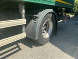 a large green truck with a yellow stripe on it ' s side