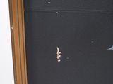 a hole in the wall of a room with a door open